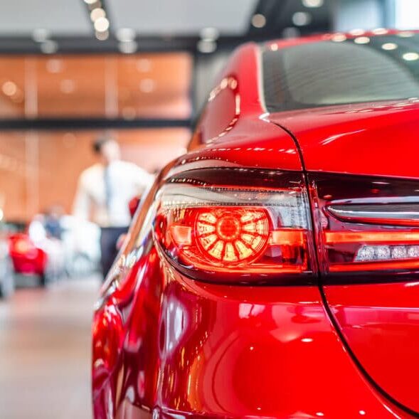 rear view of new modern red car led tail lights in showroom